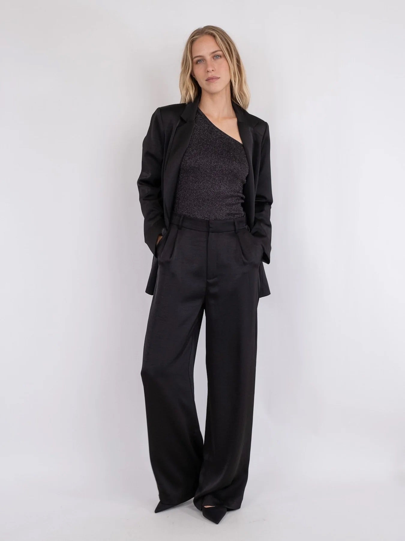 Model wearing Neo Noir Alessandra Heavy Sateen Pants – Black with a stylish blazer, showcasing women's fashion from premium brands.